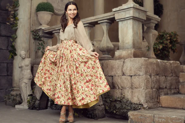 Young beautiful woman in flower skirt — Stok fotoğraf