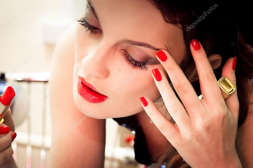Young beautiful woman doing makeup