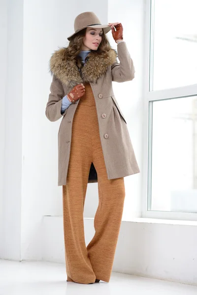 Girl in studio posing at coat — Stock Photo, Image