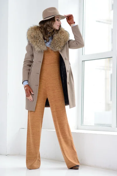 Girl in studio posing at coat — Stock Photo, Image