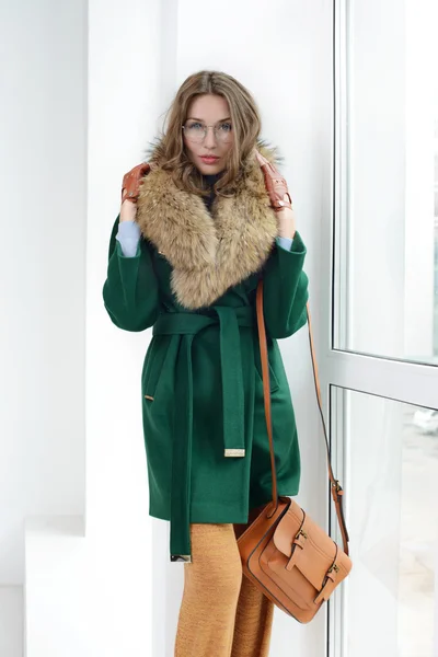 Girl in studio posing at coat — Stock Photo, Image