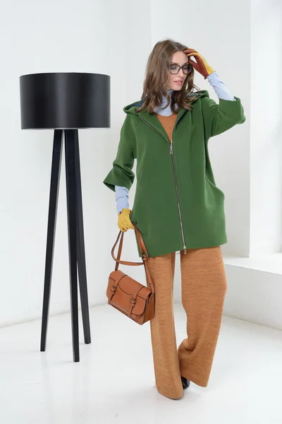 Girl in studio posing at coat — Stock Photo, Image