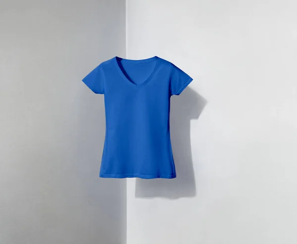 blue v-neck shaped t-shirt for women on white and grey background