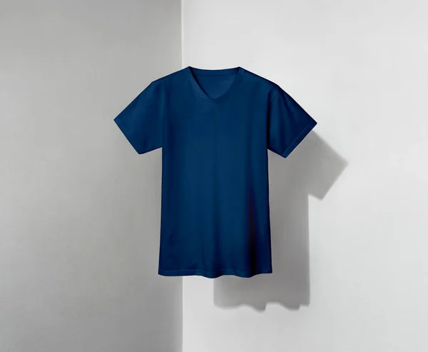 blue t-shirt with v-shaped neck and short sleeves on grey and white background