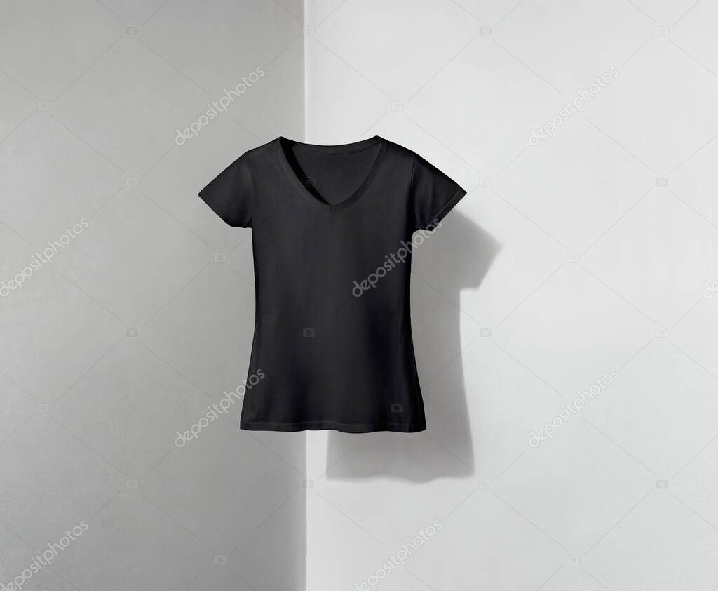 Black v-neck shaped t-shirt for women on white and grey background