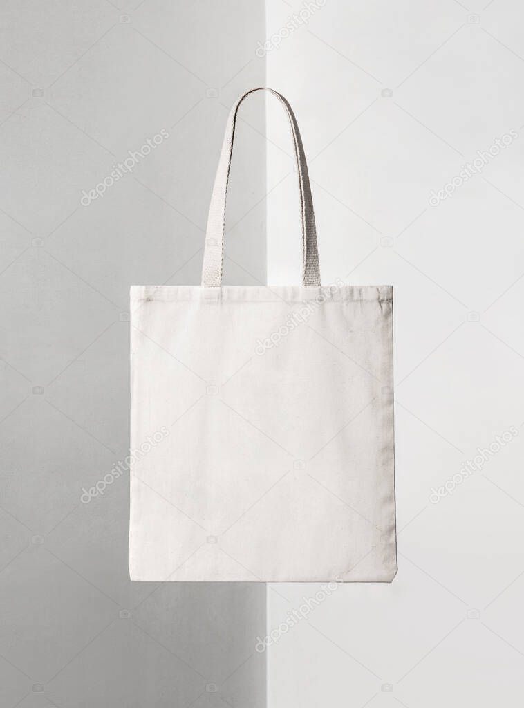 Tote squared bag with light beige fabric on light white and grey background