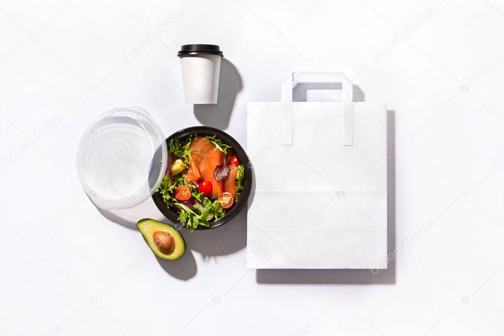 Identity set with take away box with salmon avocado salad coffe cup and paper bag on white background
