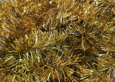 Altın folyo dokusu. Kış tatili için altın süslemeli metalik arka plan. Noel ve yeni yıl dekorasyonu.