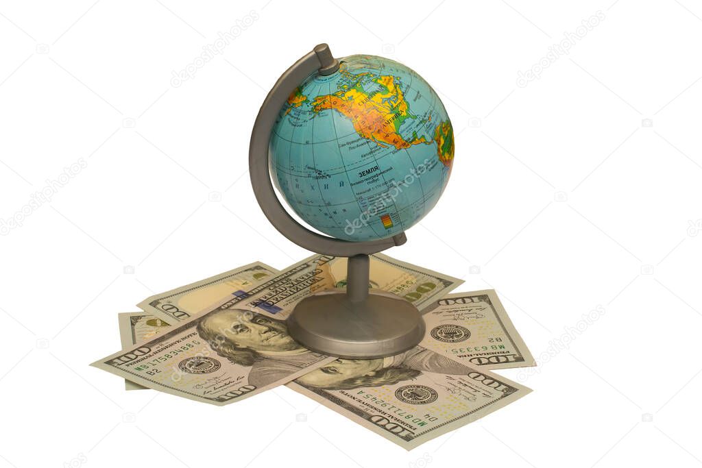 small globe stands on a heap of dollars on a white background