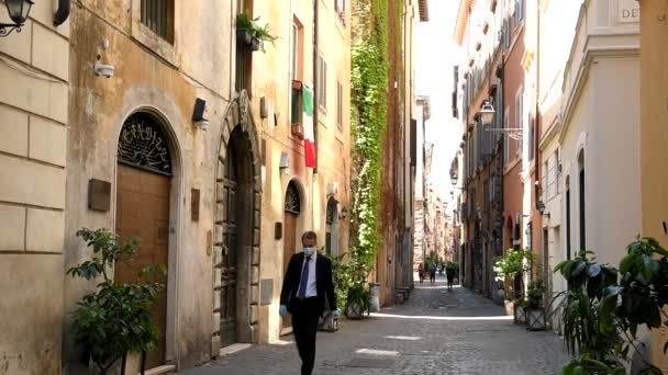 Roma, 1 de mayo de 2020: Hombre con máscara y guantes en calles desiertas debido al cierre — Vídeo de stock