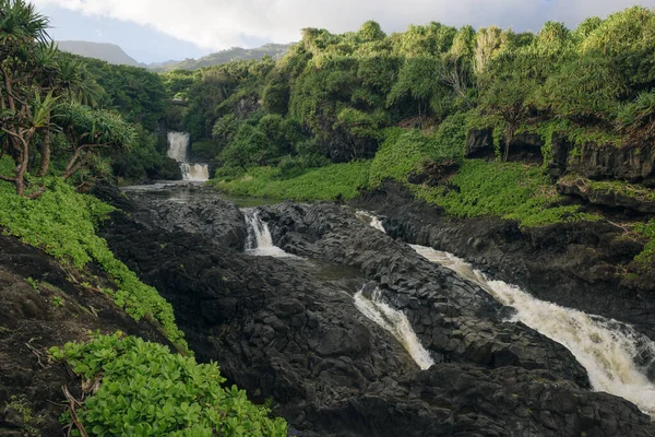 Ohe 'o Gulch' un dramatik şelaleleri Haleakala Ulusal Parkı, Kipahula, Maui, Hawaii, ABD 'de bir köprünün altındaki kayalıklardan aşağı dökülüyor. Yüksek kalite fotoğraf