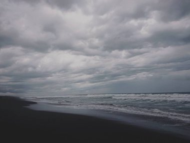 Dalgaların ve kumsaldaki kum manzaralarının fotoğrafları.