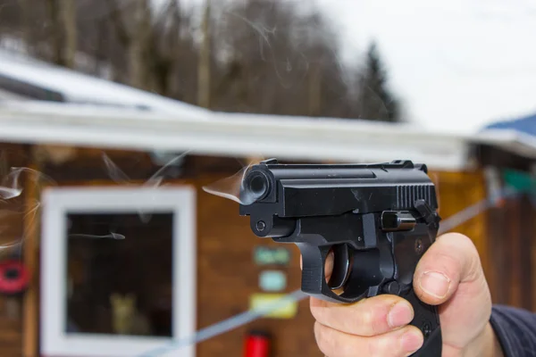 Woman shooting outdoor with a gun,  selective focus — Stock Photo, Image