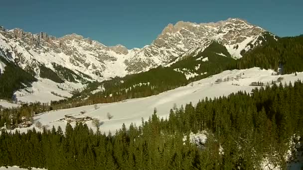 Aerial view of the mountains in the alps, mountain peaks camera swiveling about rock and winter landscape — Stock Video
