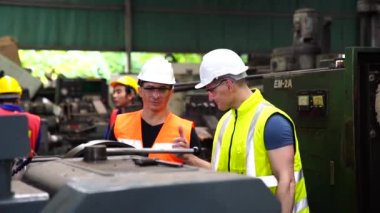 Otomatik Değirmen Makinesi Mühendis ve Çırak. Makinede gözlüklü ve miğferi olan bir işçi.