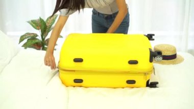 Seyahat hazırlığı da eğlenceli ve mutlu anlardan biridir. Seyahat için bavulunu toplayan bir kadın..