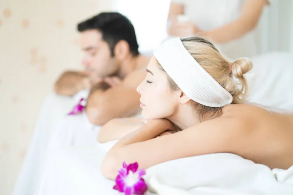 Man and woman relax in skin care aroma therapy and spa ball, in Thailand resort.