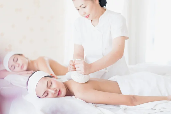 Woman relax in skin care aroma therapy and spa ball, in Thailand resort. Female relaxing and smile. Young woman relaxing with hot spa massage at spa salon