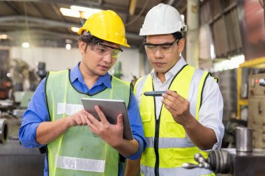 Teknisyenler ve mühendisler yedek parçaların parçalarını sanayi tesislerindeki tabletlerden alınan örneklerle karşılaştırıyorlar. 