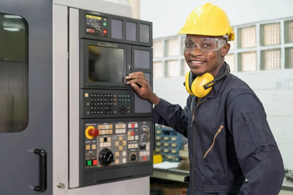 Professional technicians are controlling industrial machinery online. Engineer working and control robot with tablet. Young technicians factory worker controlling the work.