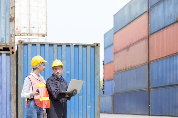 Import and Export concept. Container Shipping Logistics of import and export transportation industry. Businessman manager using laptop check orders in warehouse logistics.