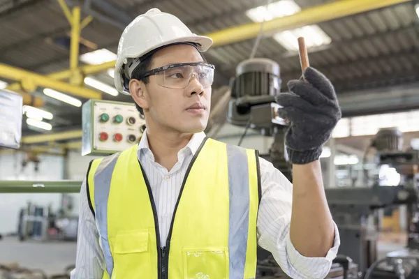 A technician or engineer is inspecting copper pipes in the refrigeration industry.