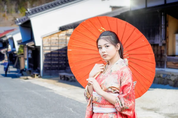 Asian woman tourists. Beautiful girl wearing traditional japanese kimono in Tsumago juku is now popular in village at Nagano Prefecture, Japan.