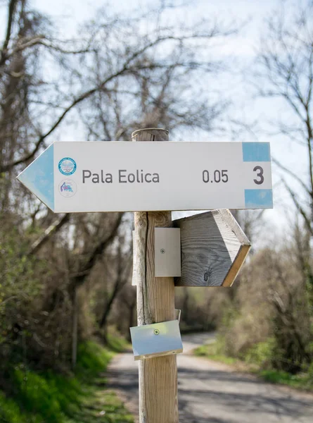 Señal de calle de madera que muestra la dirección a un parque eólico . — Foto de Stock