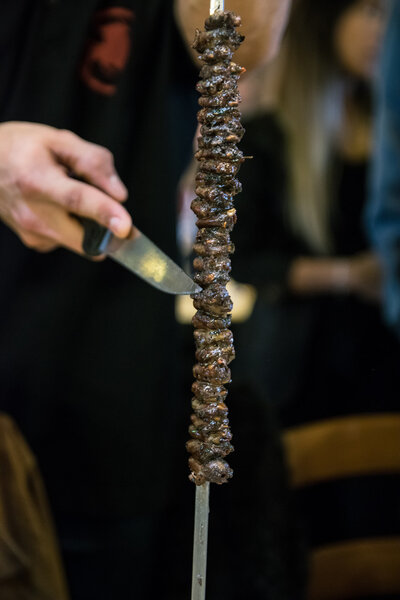 Meat skewered on a spit served to the table.