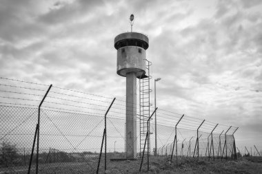 Dikenli tel ile net tarafından izole terk edilmiş nöbetçi kutusu tower.