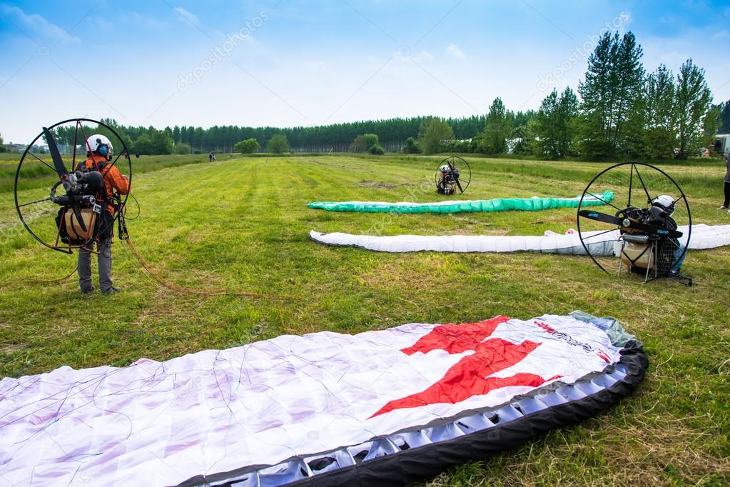 motorized paragliders are ready to go from a green field