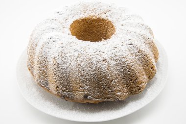 classic cake with icing sugar and hole in the center clipart