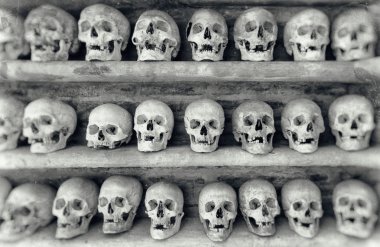 Human skulls inside a catacomb. clipart