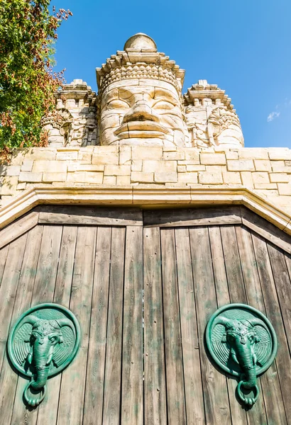 Caras de piedra de un templo y portal de madera . — Foto de Stock
