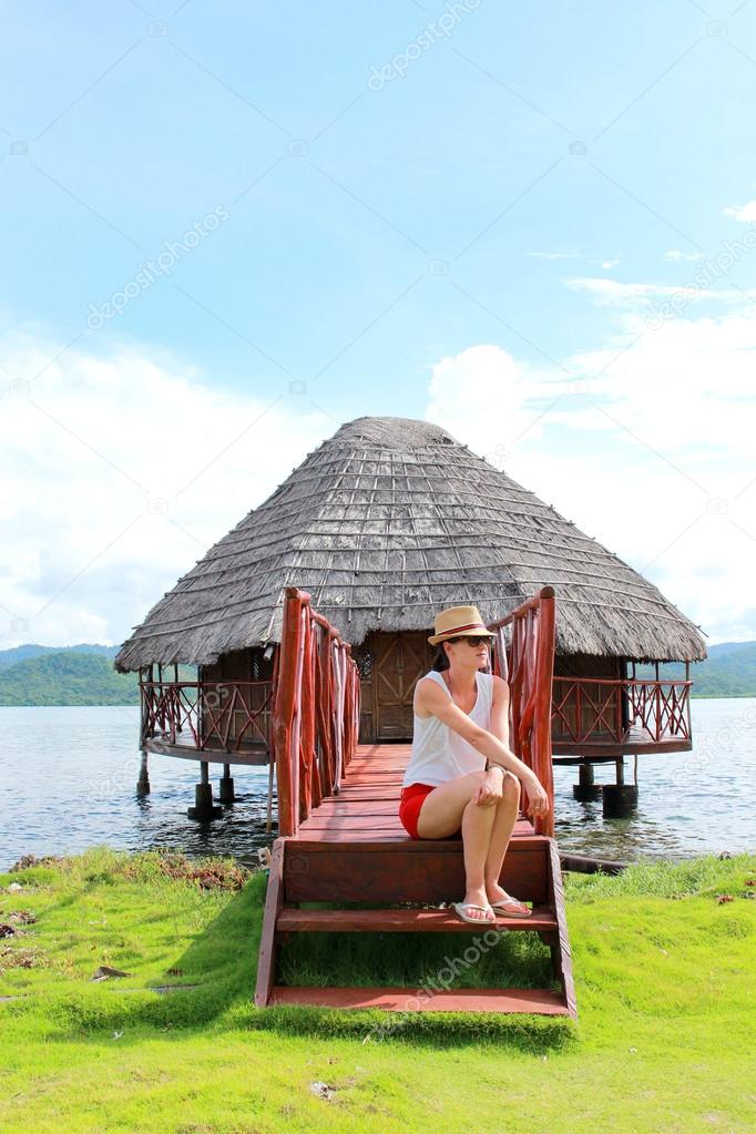 Young beautiful woman enjoying her time and resting close to the sea in Yandup lodge's private cabins, Yandup Island, San Blas, Panama