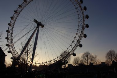 London Eye in Waterloo, London - February 15th of 2015: This is the third largest ferris wheel all around the world. This tourist attraction is 135 meters tall with a diameter of 120 metres. clipart