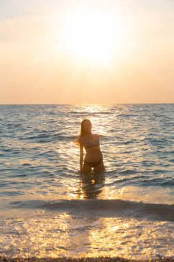 Güzel genç kız sahilde dinleniyor.