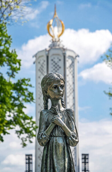 Kyiv, Ukraine - May 14, 2021: sculpture of a girl "Bitter childhood memory",  National Museum of the Holodomor-Genocide in Kyiv, Ukraine, created by the project of the artist Anatoly Gaydamaka