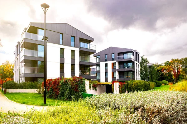 New modern residential block buildings and autumn park. Housing development in Europe