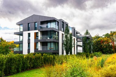 New modern residential block buildings and autumn park. Housing development in Europe
