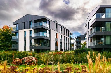 New modern residential block buildings and autumn park. Housing development in Europe