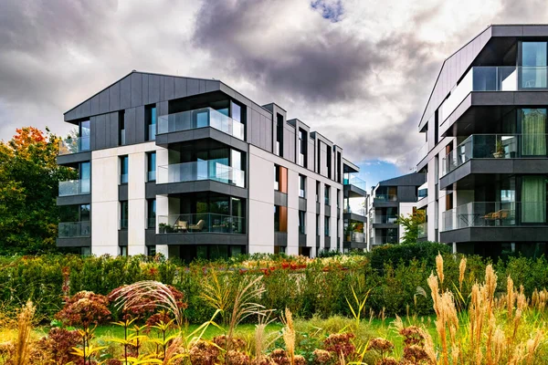 New modern residential block buildings and autumn park. Housing development in Europe
