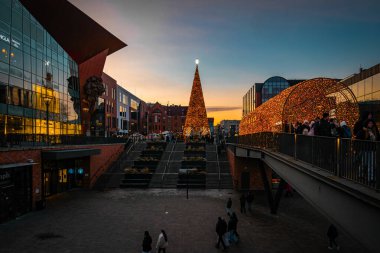 Gdansk, Poland - November 23, 2025: Illuminated shiny Christmas tree and Forum shopping mall in Gdansk. Winter holidays in Poland