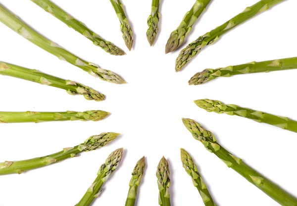 Food background, green asparagus tips in a circle, white background — Stock Photo, Image