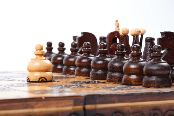 Courageous Pawn standing in front of opposing lineup, old wooden Chess Game — Stock Photo, Image