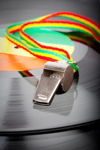 Vintage vinyl record with silver whistle, red, yellow, green cord and label — Stock Photo, Image