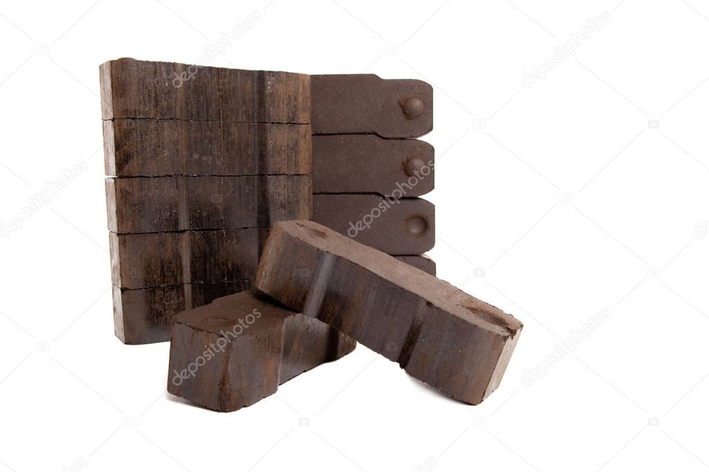 Coal with two carbon bricks on white background