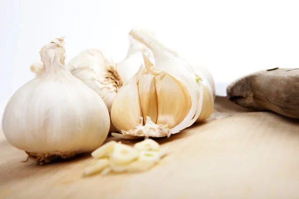 Some clove of garlic on wooden board Royalty Free Stock Photos