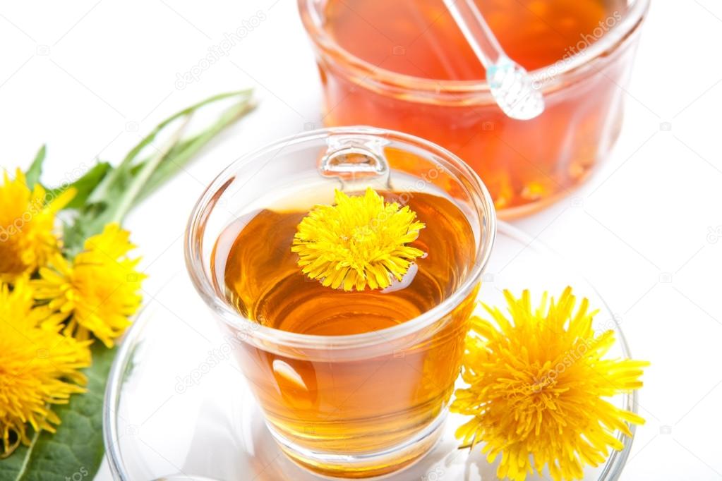 Dandelion herbal tea on white background, with honey and blossoms