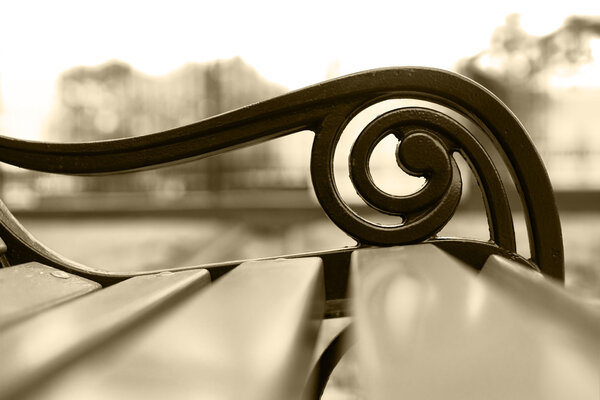 Horizontal sepia park bench bokeh background